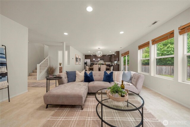 living room with light carpet, stairway, recessed lighting, and baseboards