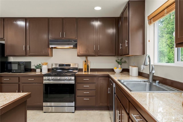 kitchen featuring appliances with stainless steel finishes, under cabinet range hood, a sink, recessed lighting, and dark brown cabinets