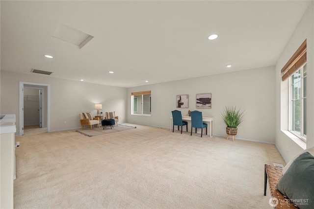 living area featuring light carpet, recessed lighting, attic access, and baseboards