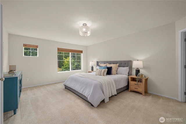 bedroom featuring light colored carpet and baseboards