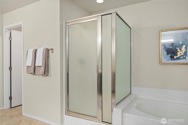 full bath featuring a shower stall, a garden tub, and recessed lighting