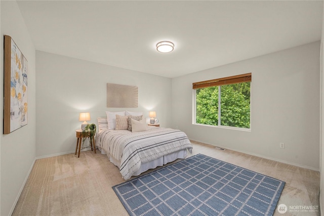 bedroom featuring carpet and baseboards