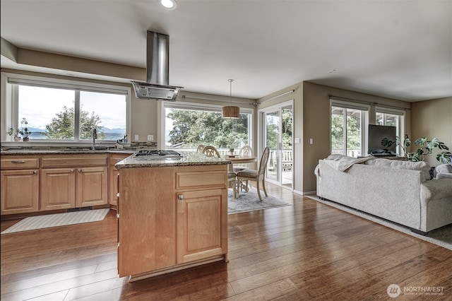 2660 NW Canal View Way, Poulsbo, WA 98370 - kitchen featuring island exhaust hood, open floor plan, stainless steel gas cooktop, dark stone countertops, and dark wood finished floors