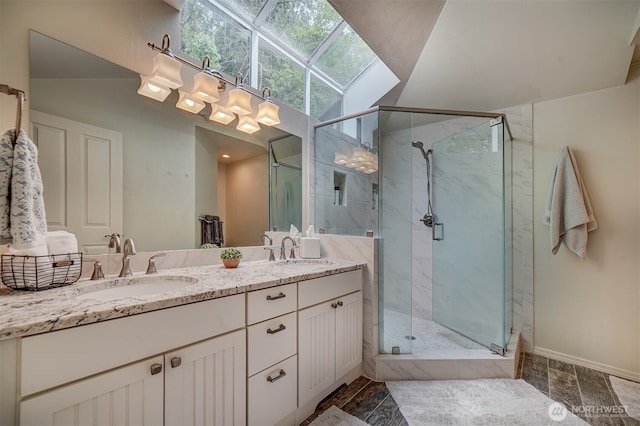 2660 NW Canal View Way, Poulsbo, WA 98370 - bathroom with a marble finish shower, double vanity, a skylight, and baseboards
