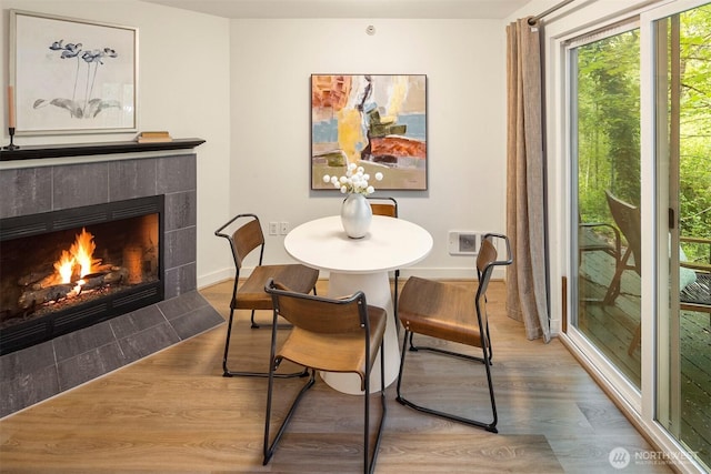 700 Front St S Unit D106, Issaquah, WA 98027 - dining area with a tile fireplace, wood finished floors, and baseboards