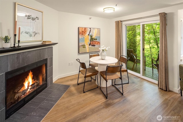 700 Front St S Unit D106, Issaquah, WA 98027 - dining space with a tile fireplace, wood finished floors, and baseboards