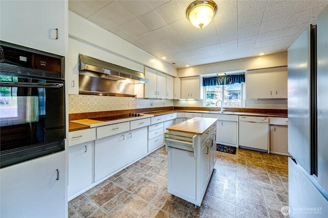 833 S Point Rd, Port Ludlow, WA 98365 - kitchen featuring black appliances, a sink, range hood, light stone finish flooring, and wooden counters