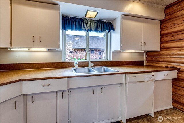 833 S Point Rd, Port Ludlow, WA 98365 - kitchen featuring white dishwasher, a sink, rustic walls, and white cabinets
