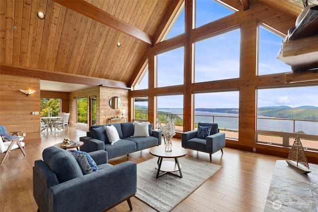790 N Hamma Ridge Dr, Lilliwaup, WA 98555 - living room with high vaulted ceiling, hardwood / wood-style flooring, a water view, wooden walls, and wooden ceiling with exposed beams