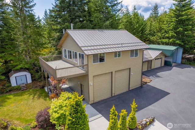 790 N Hamma Ridge Dr, Lilliwaup, WA 98555 - view of front of property with a standing seam roof, metal roof, a front lawn, a wooded view, and a wooden deck