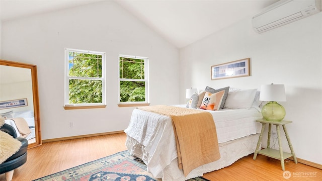 6508 NE Plum St, Suquamish, WA 98392 - bedroom with a wall mounted AC, wood finished floors, and high vaulted ceiling