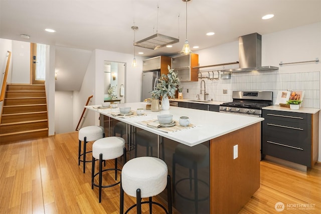 1833 27th Ave, Seattle, WA 98122 - kitchen featuring stainless steel appliances, island exhaust hood, a sink, light countertops, and recessed lighting