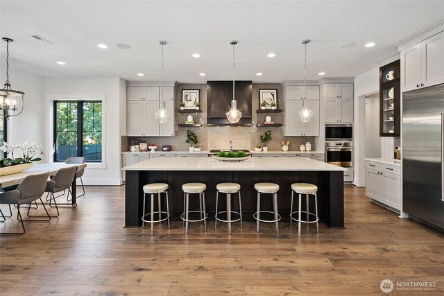 27 Tulalip Ky, Bellevue, WA 98006 - kitchen with built in appliances, premium range hood, light countertops, open shelves, and recessed lighting