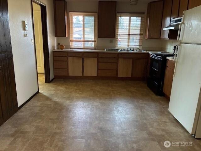 1115 156th St E, Tacoma, WA 98445 - kitchen featuring freestanding refrigerator, black electric range, light countertops, and light flooring