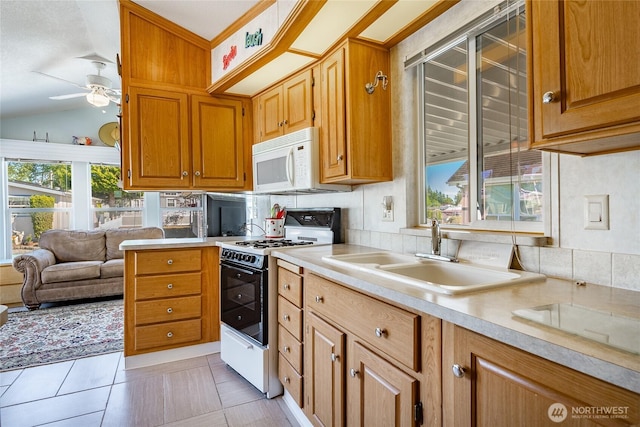 4751 Birch Bay Lynden Rd Unit 51, Blaine, WA 98230 - kitchen featuring gas stove, white microwave, a sink, light countertops, and a ceiling fan