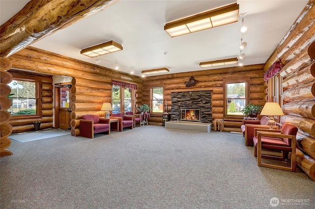 4751 Birch Bay Lynden Rd Unit 51, Blaine, WA 98230 - living area featuring rail lighting, carpet floors, a stone fireplace, and rustic walls
