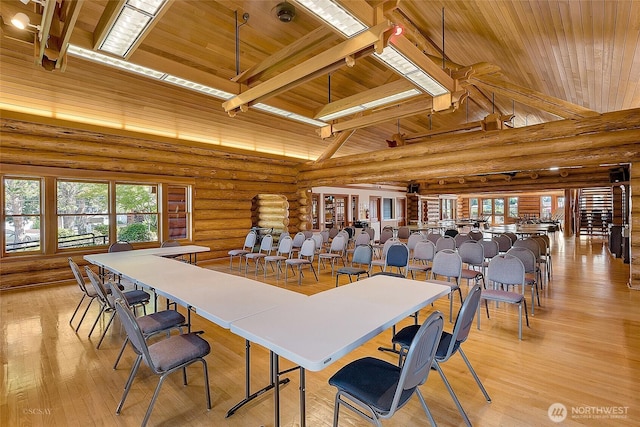 4751 Birch Bay Lynden Rd Unit 51, Blaine, WA 98230 - dining room with wood ceiling with exposed beams, healthy amount of natural light, log walls, light wood finished floors, and high vaulted ceiling
