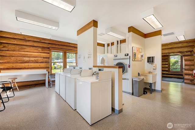 4751 Birch Bay Lynden Rd Unit 51, Blaine, WA 98230 - community laundry room featuring washer and dryer, log walls, plenty of natural light, and baseboards