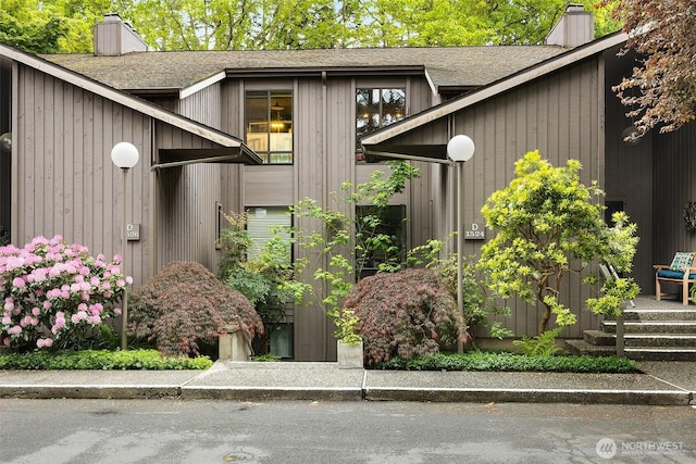 1524 NE 140th Unit D2, Seattle, WA 98125 - entrance to property with a chimney and roof with shingles