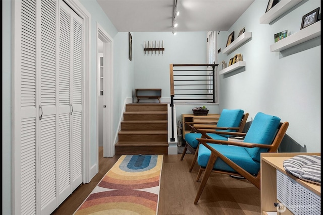 1524 NE 140th Unit D2, Seattle, WA 98125 - sitting room featuring rail lighting, wood finished floors, and stairs