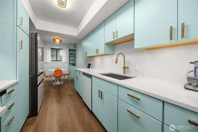 1524 NE 140th Unit D2, Seattle, WA 98125 - kitchen featuring a sink, stainless steel dishwasher, freestanding refrigerator, dark wood-type flooring, and tasteful backsplash