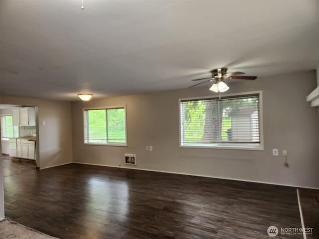 12597 US Highway 12, Randle, WA 98377 - unfurnished living room with dark wood-type flooring, ceiling fan, heating unit, and baseboards