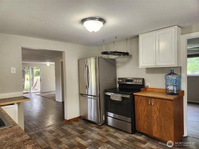 12597 US Highway 12, Randle, WA 98377 - kitchen featuring stainless steel appliances, dark wood-style floors, white cabinetry, and baseboards