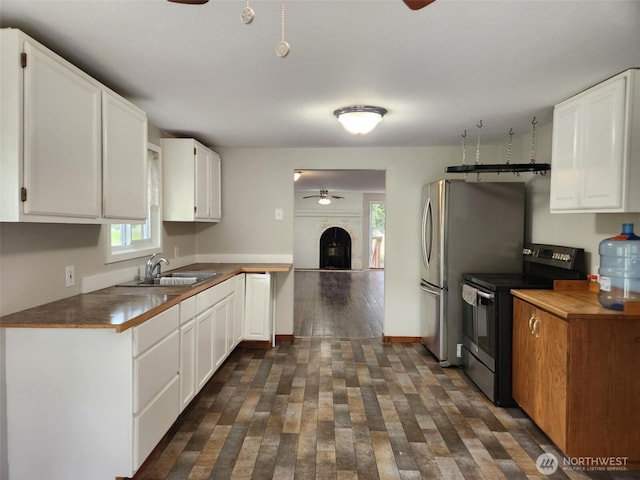 12597 US Highway 12, Randle, WA 98377 - kitchen featuring stainless steel electric range oven, a ceiling fan, a sink, dark wood finished floors, and white cabinetry