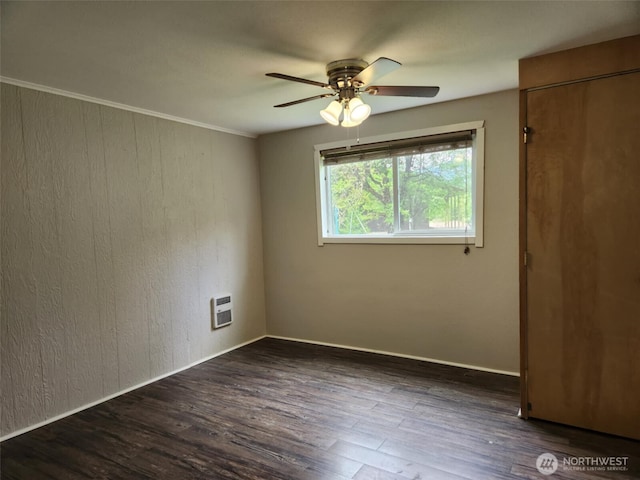 12597 US Highway 12, Randle, WA 98377 - spare room featuring ceiling fan, dark wood-type flooring, heating unit, baseboards, and crown molding