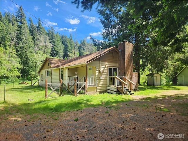 12597 US Highway 12, Randle, WA 98377 - view of front facade with a chimney, a front yard, driveway, and a forest view