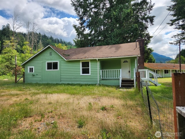 12597 US Highway 12, Randle, WA 98377 - rear view of house featuring a chimney, a porch, and a mountain view