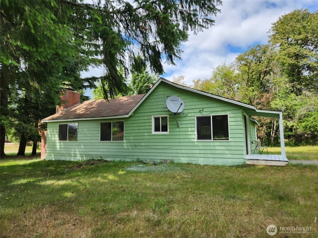 12597 US Highway 12, Randle, WA 98377 - view of side of property with a lawn, a chimney, and a deck