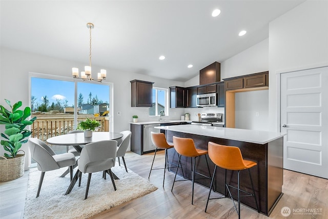 1413 Alder Ln, Gold Bar, WA 98251 - kitchen featuring appliances with stainless steel finishes, dark brown cabinets, a chandelier, a kitchen island, and light countertops