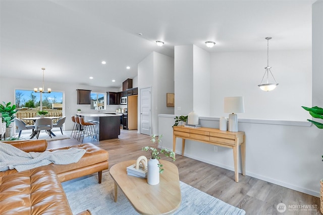 1413 Alder Ln, Gold Bar, WA 98251 - living room featuring a chandelier, light wood-style floors, vaulted ceiling, recessed lighting, and baseboards