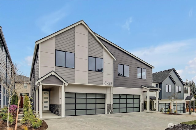 21411 39th Dr SE Unit A, Bothell, WA 98021 - contemporary house featuring a garage, stone siding, and concrete driveway