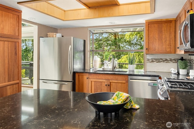 3716 Lake Washington Blvd SE Unit C, Bellevue, WA 98006 - kitchen featuring a sink, appliances with stainless steel finishes, dark stone counters, and decorative backsplash