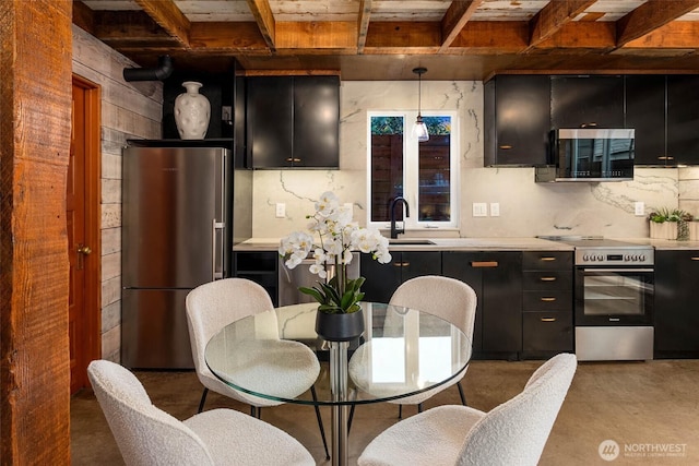 4256 S Spencer St Unit 2, Seattle, WA 98118 - kitchen featuring stainless steel appliances, dark cabinets, light countertops, finished concrete flooring, and wood ceiling with exposed beams
