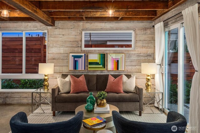 4256 S Spencer St Unit 2, Seattle, WA 98118 - living area featuring concrete flooring, wood walls, and beamed ceiling