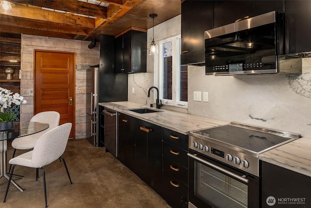 4256 S Spencer St Unit 2, Seattle, WA 98118 - kitchen featuring stainless steel appliances, dark cabinets, a sink, concrete floors, and wood walls