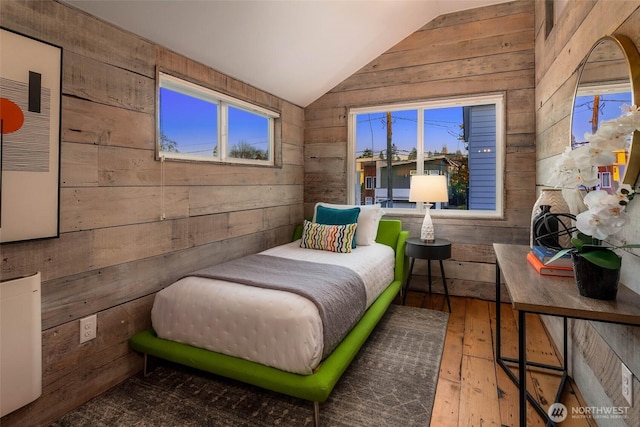 4256 S Spencer St Unit 2, Seattle, WA 98118 - bedroom featuring wood walls, vaulted ceiling, and hardwood / wood-style flooring