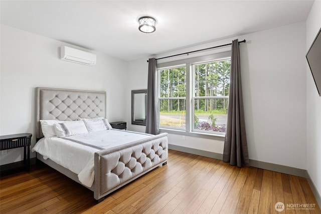321 W Berry Ridge Rd, Shelton, WA 98584 - bedroom featuring a wall unit AC, baseboards, and wood-type flooring