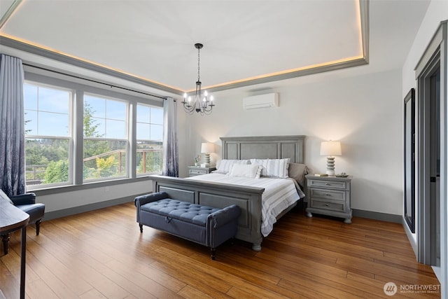 321 W Berry Ridge Rd, Shelton, WA 98584 - bedroom with a tray ceiling, a wall unit AC, a chandelier, and baseboards