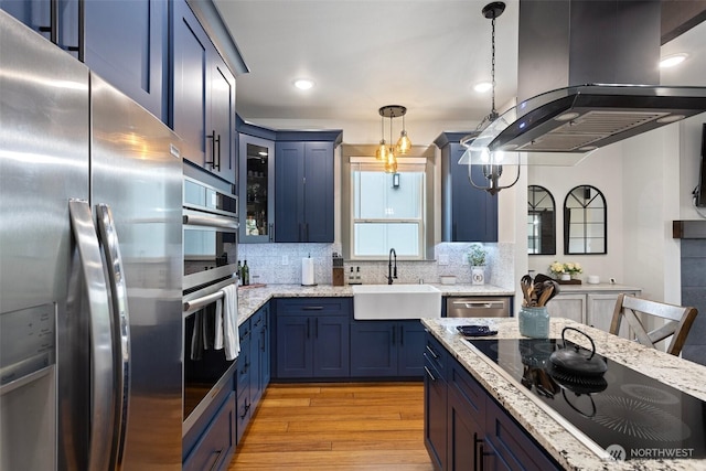 321 W Berry Ridge Rd, Shelton, WA 98584 - kitchen with stainless steel appliances, a sink, blue cabinetry, island range hood, and light wood-type flooring
