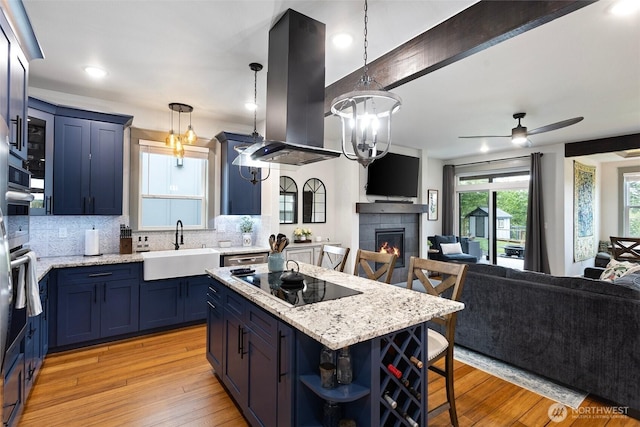 321 W Berry Ridge Rd, Shelton, WA 98584 - kitchen with black electric cooktop, open floor plan, blue cabinetry, a sink, and beam ceiling