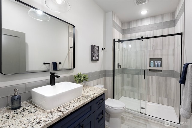 321 W Berry Ridge Rd, Shelton, WA 98584 - bathroom with toilet, vanity, a shower stall, and tile walls