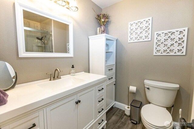 19 Mckay Pl, Walla Walla, WA 99362 - full bathroom with toilet, vanity, wood finished floors, and an enclosed shower
