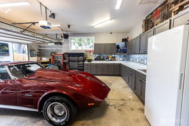 19 Mckay Pl, Walla Walla, WA 99362 - garage with freestanding refrigerator and a garage door opener