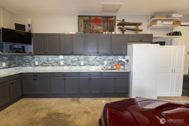 19 Mckay Pl, Walla Walla, WA 99362 - kitchen with a sink, freestanding refrigerator, gray cabinets, decorative backsplash, and unfinished concrete floors