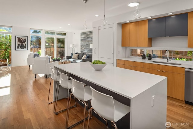 5802 43rd Ave NE, Seattle, WA 98105 - kitchen featuring a sink, modern cabinets, a breakfast bar, light countertops, and recessed lighting