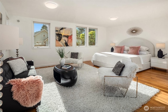 5802 43rd Ave NE, Seattle, WA 98105 - bedroom featuring wood finished floors, multiple windows, and baseboards